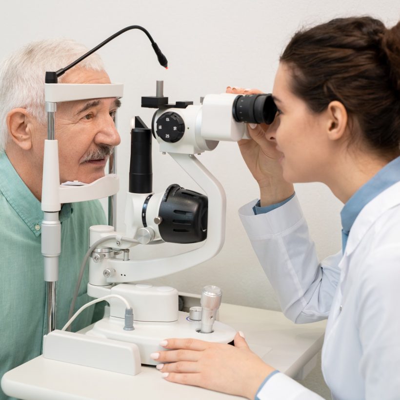 young-brunette-female-ophthalmologist-testing-eyesight-of-senior-male-patient.jpg